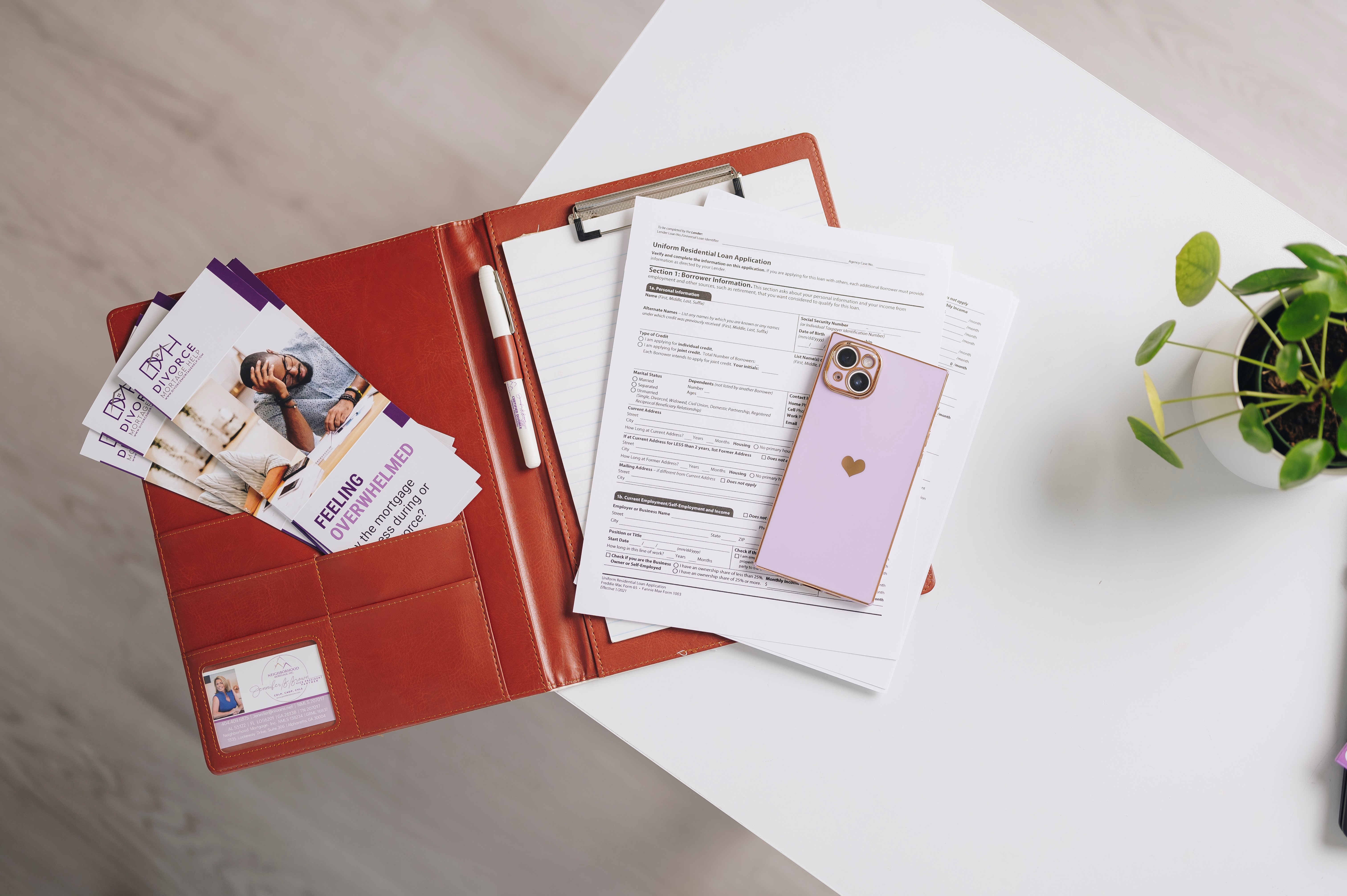 Divorce Mortgage Help materials and mortgage paperwork arranged on a desk