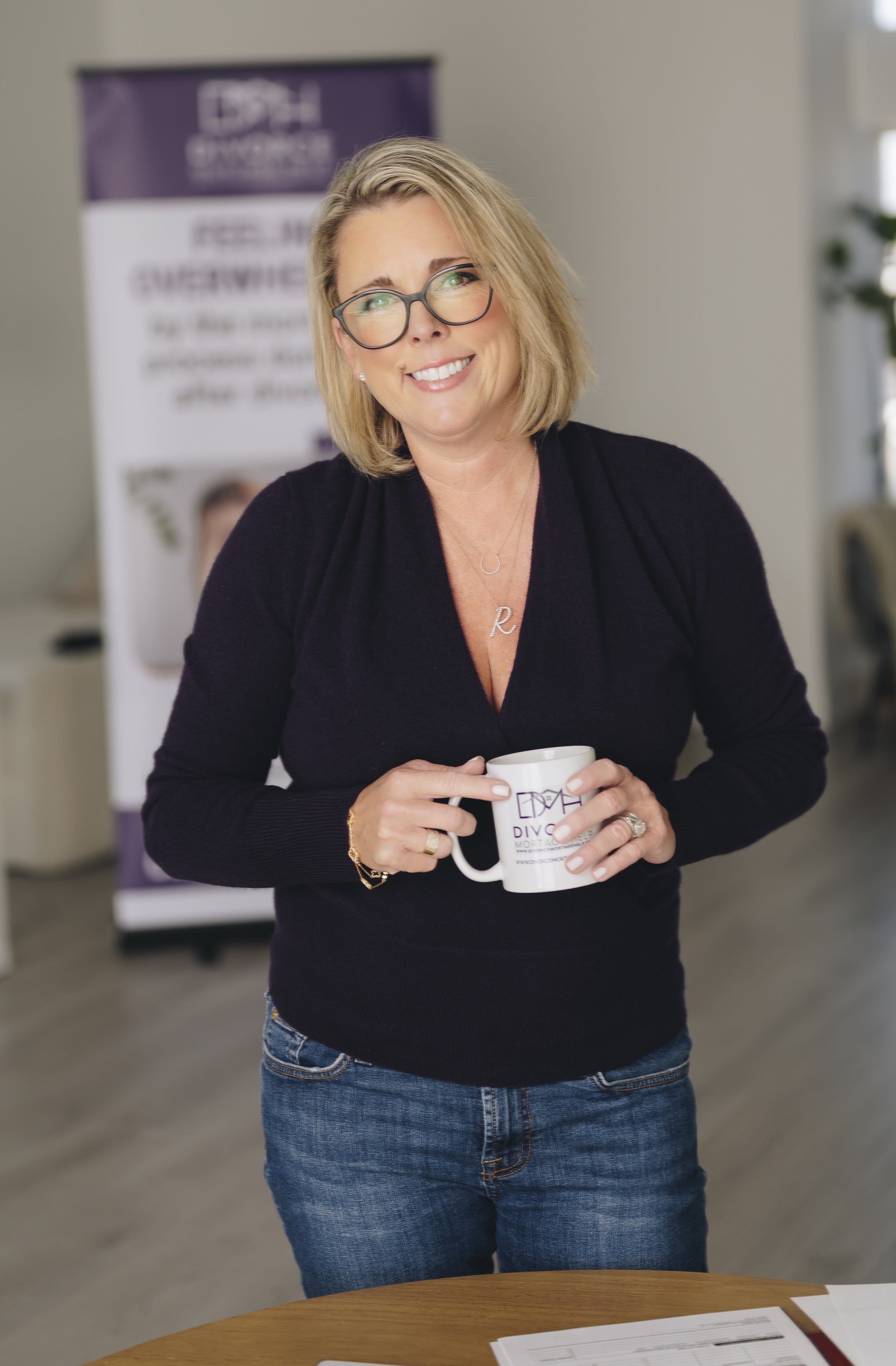 Jennifer Brown holding a Divorce Mortgage Help mug